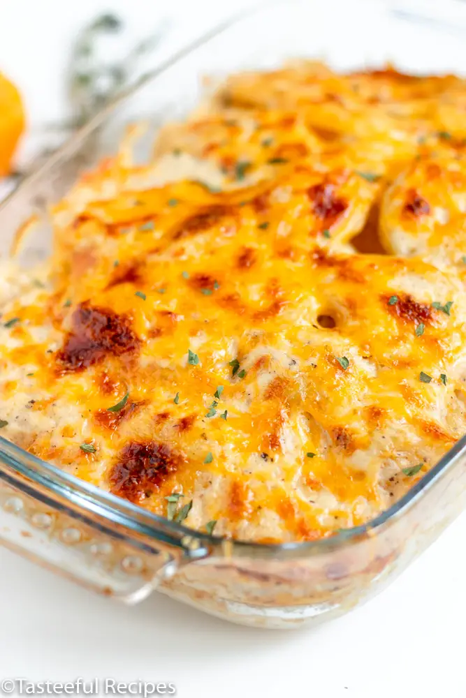 Angled shot of scalloped potatoes in a baking dish