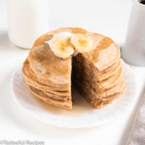 Straight on shot of a stack of peanut butter banana pancakes