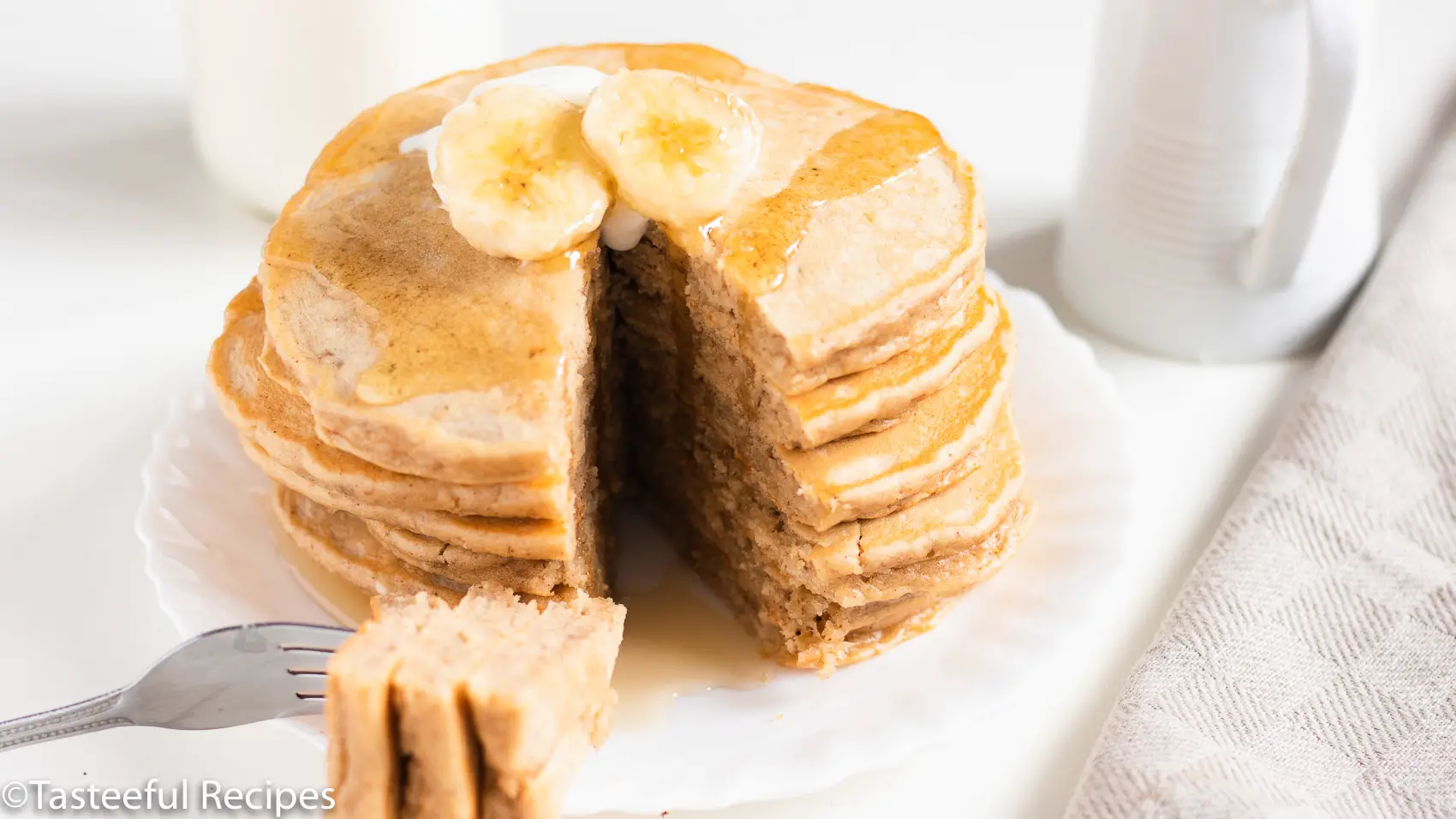 Straight on shot of a stack of peanut butter banana pancakes