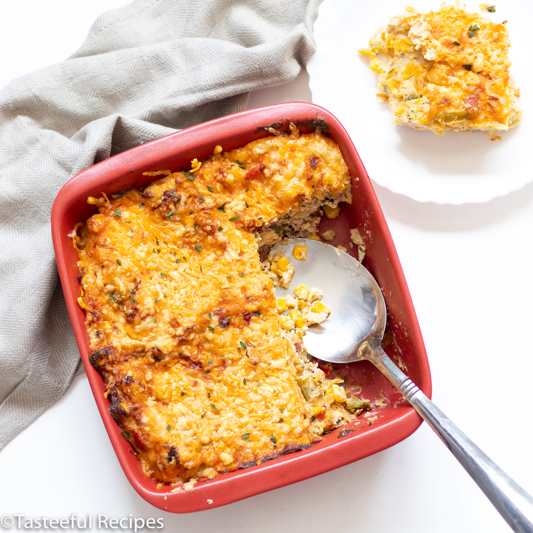 Overhead shot of Trinidad bacon corn pie with a serving spoon