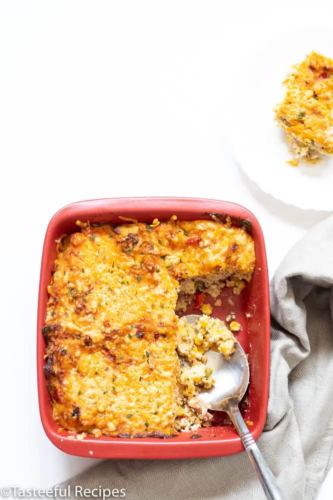 Overhead shot of Trinidad bacon corn pie with a serving spoon