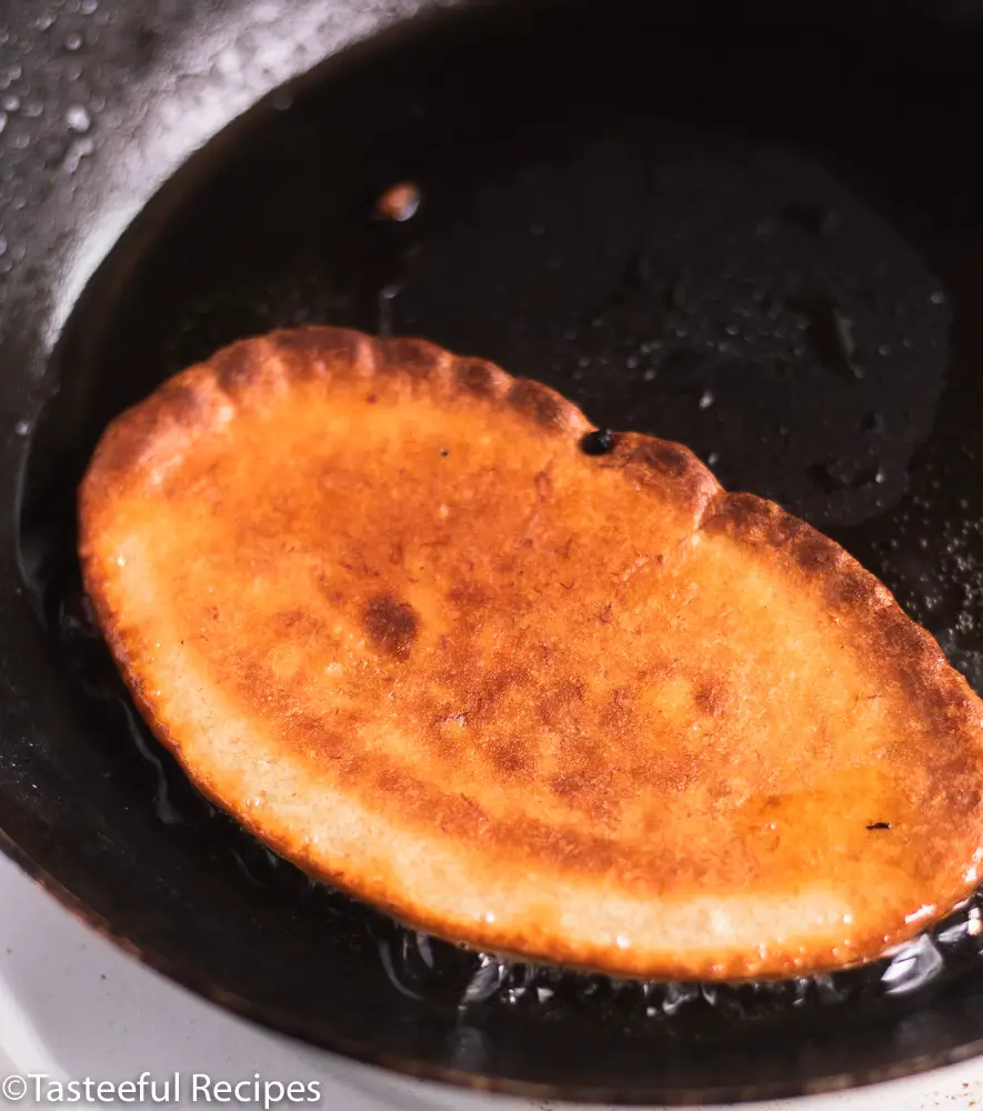 Angled shot of fritters being fried