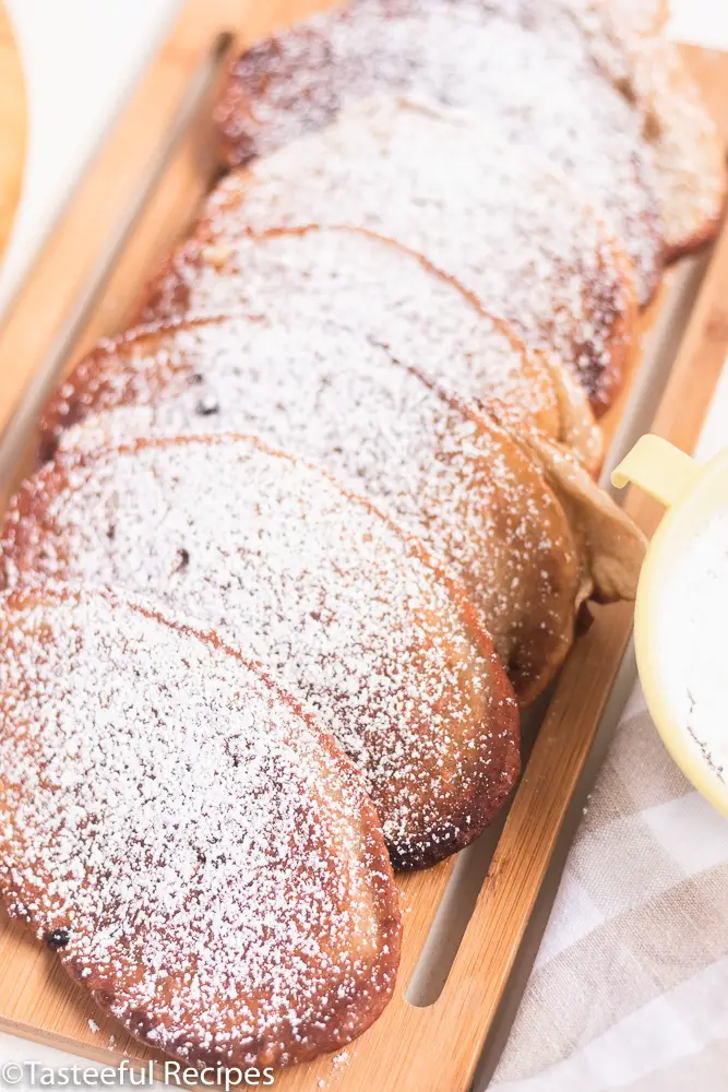 Angled shot of banana fritters on a tray