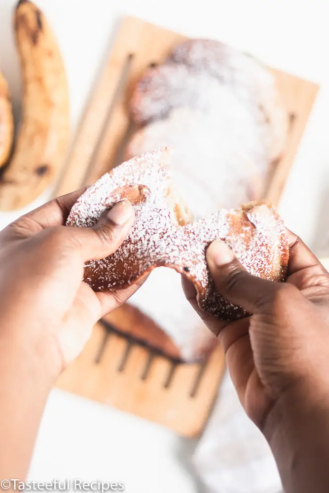 Angled shot of a banana fritters being held