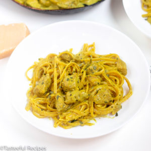 Angled shot of a plate of curry chicken pasta