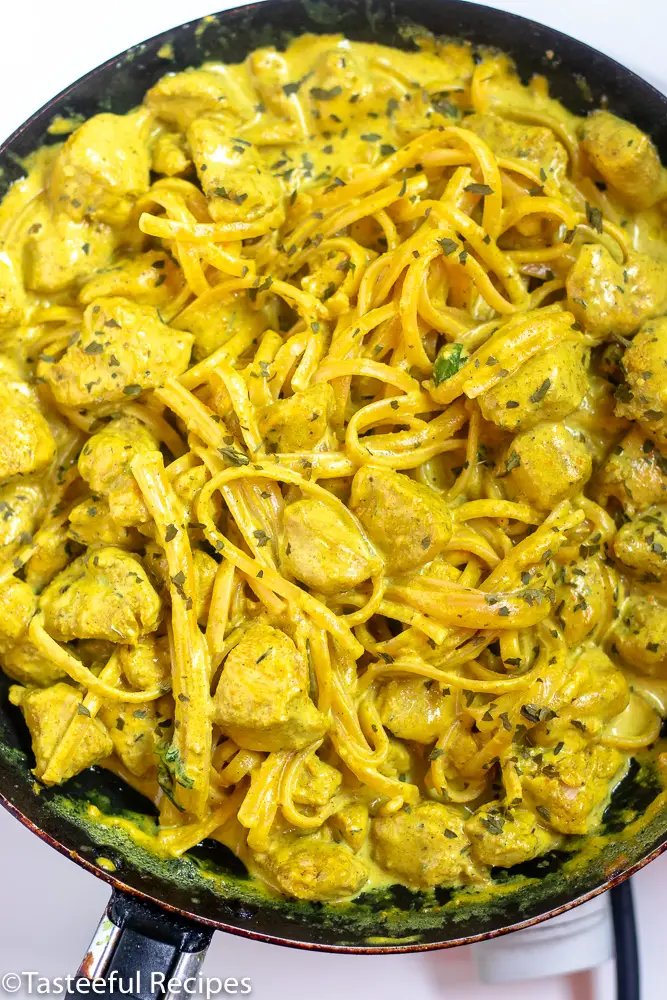 Overhead shot of a skillet filled with creamy curry chicken pasta