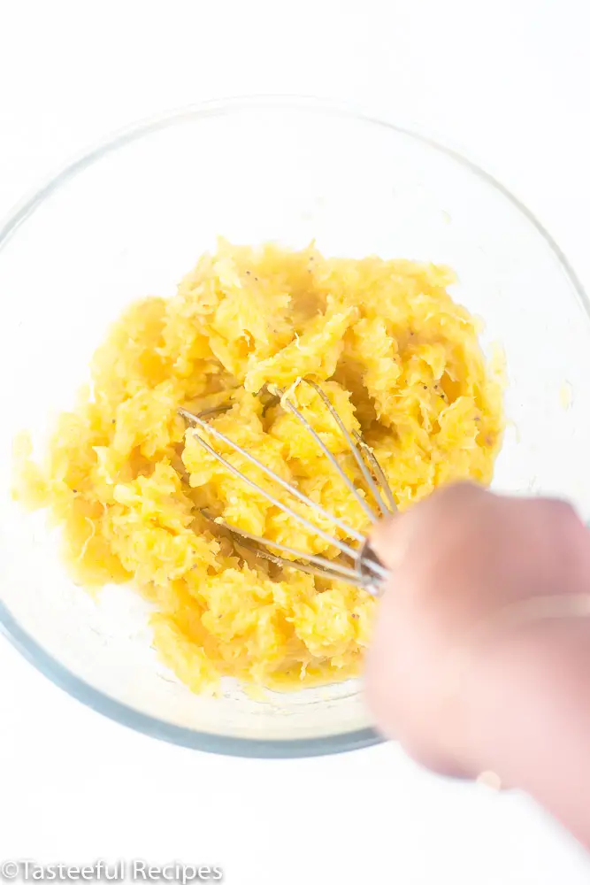 Overhead shot of Caribbean being mashed in a bowl