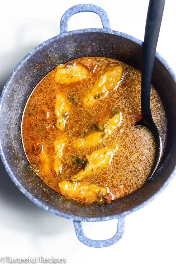 Overhead shot of a pot of West Indian conch and dumpling