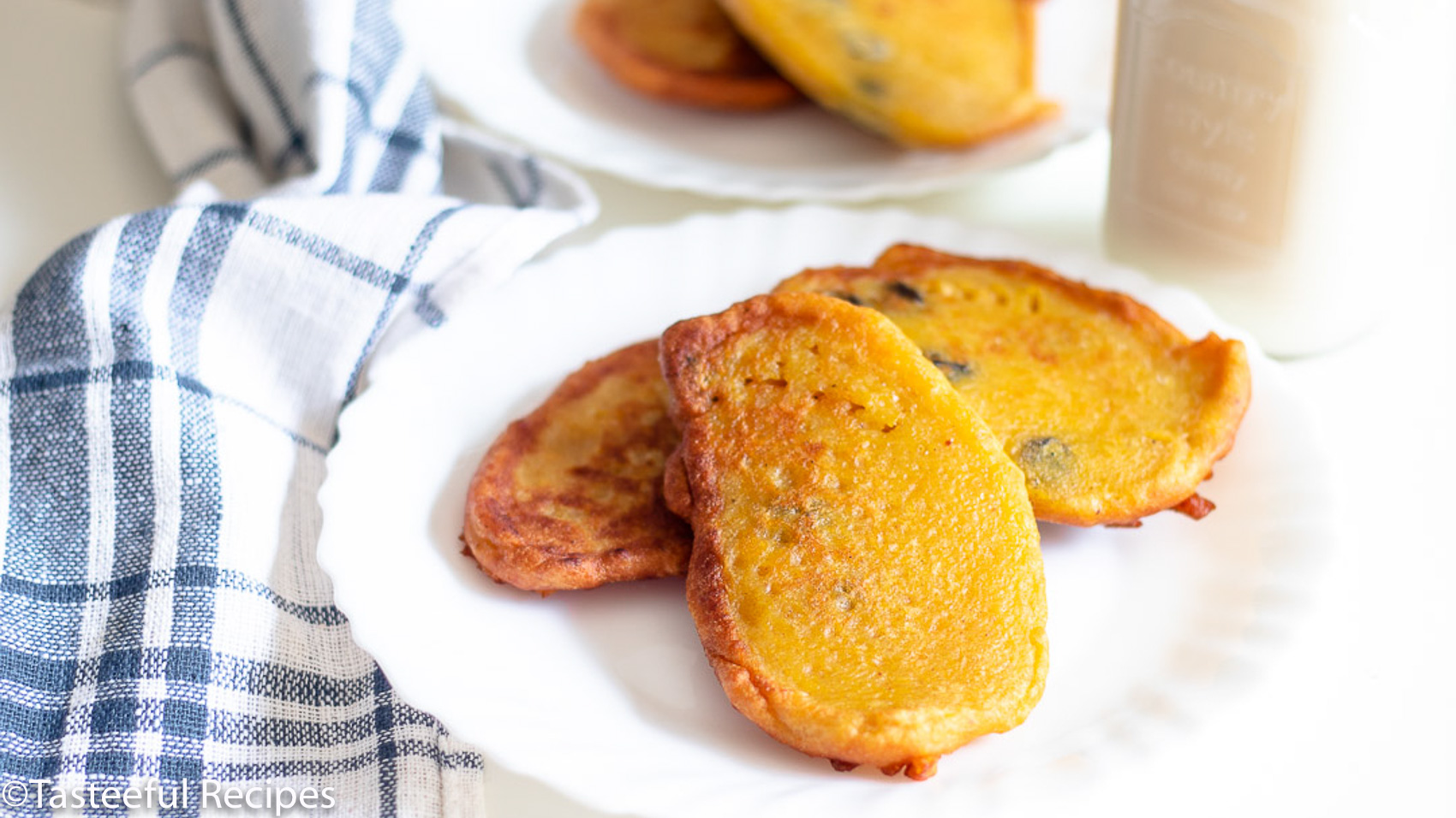 Straight on shot of a plate of Caribbean pumpkin fritters