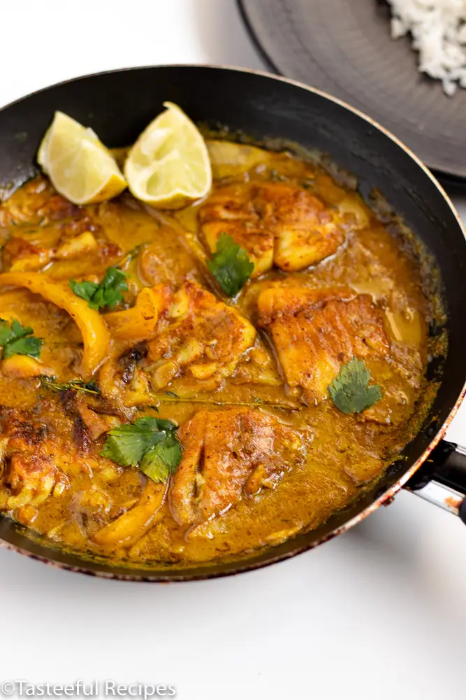 Angled shot of a skillet of curry fish