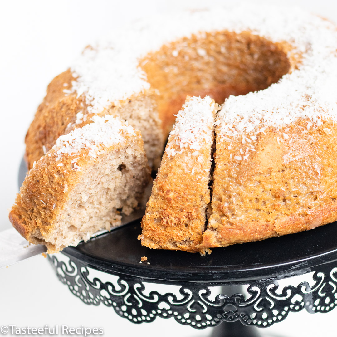 Straight on shot of a coconut plantain cake being sliced into