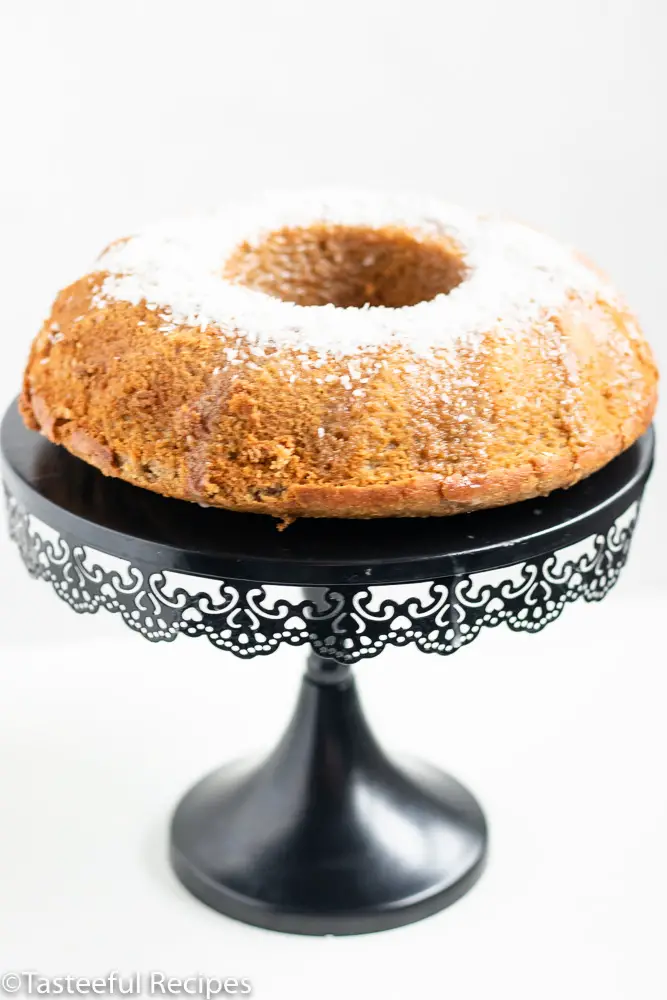 Straight on shot of coconut plantain cake on a cake stool