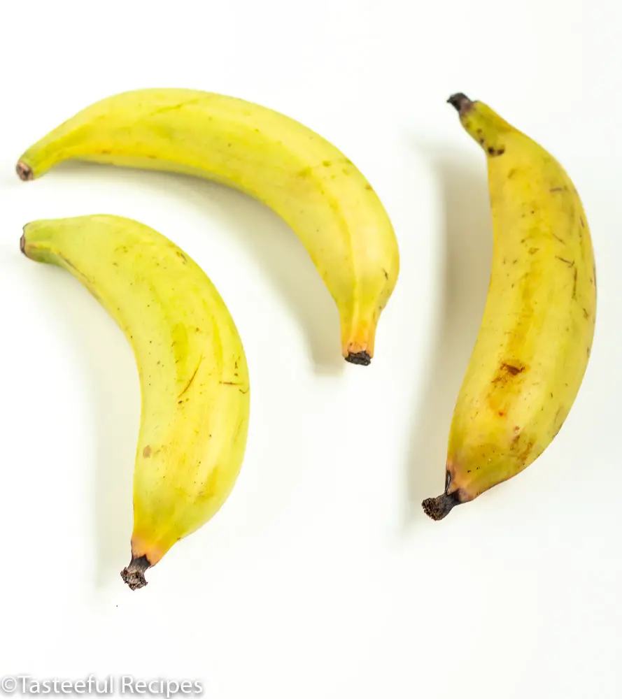 Overhead shot of three unripe plantains