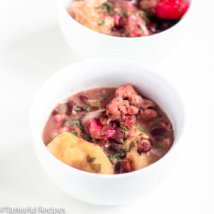 Angled shot of a bowl of pigtails and red beans soup