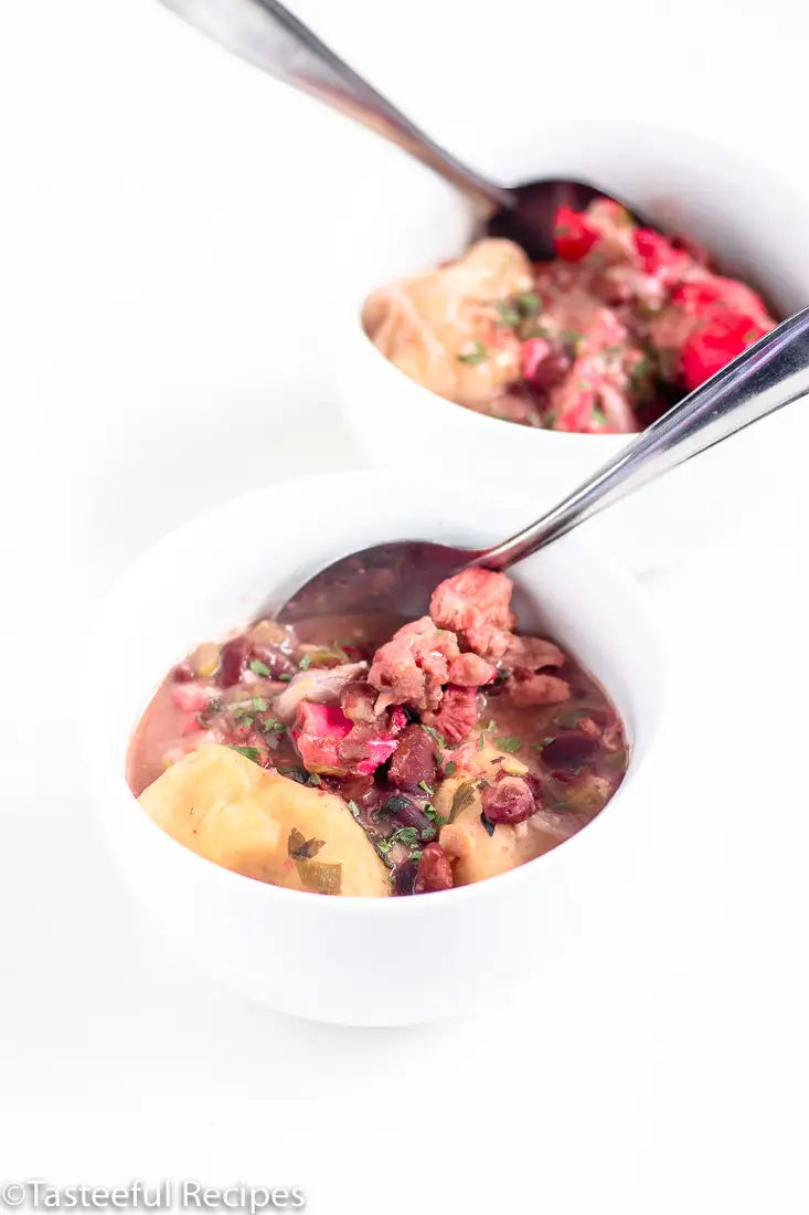 Angled shot of two bowls of pigtails and red beans soup