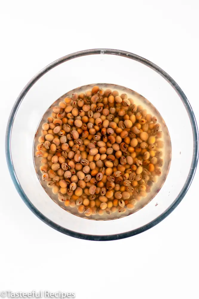 Overhead shot of a bowl filled with dry pigeon peas and water