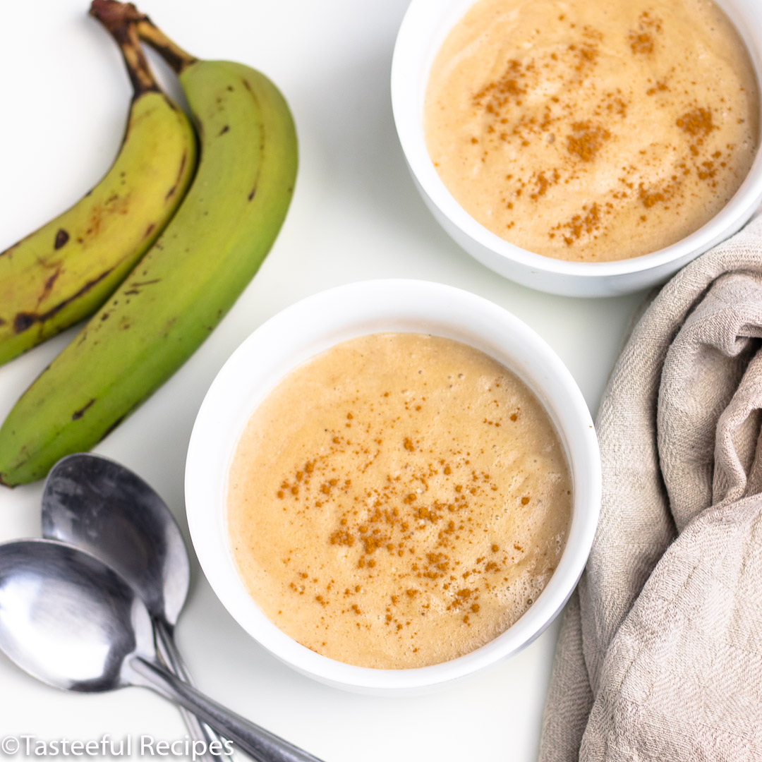 Overhead shot of two bowls of green banana porridge