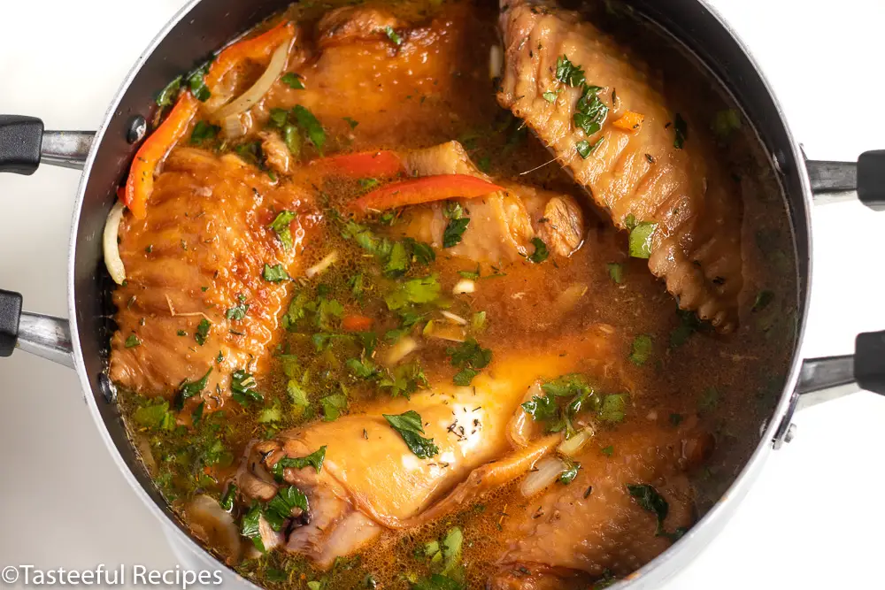 Overhead shot of Caribbean stewed turkey wings being cooked