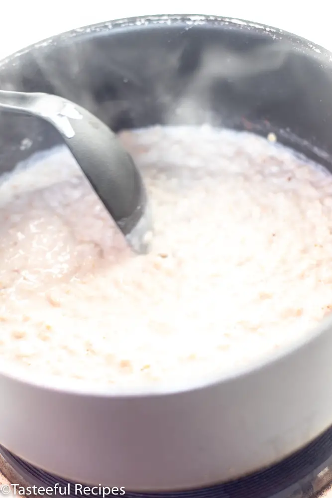 Angled shot of oats being stirred in a pot