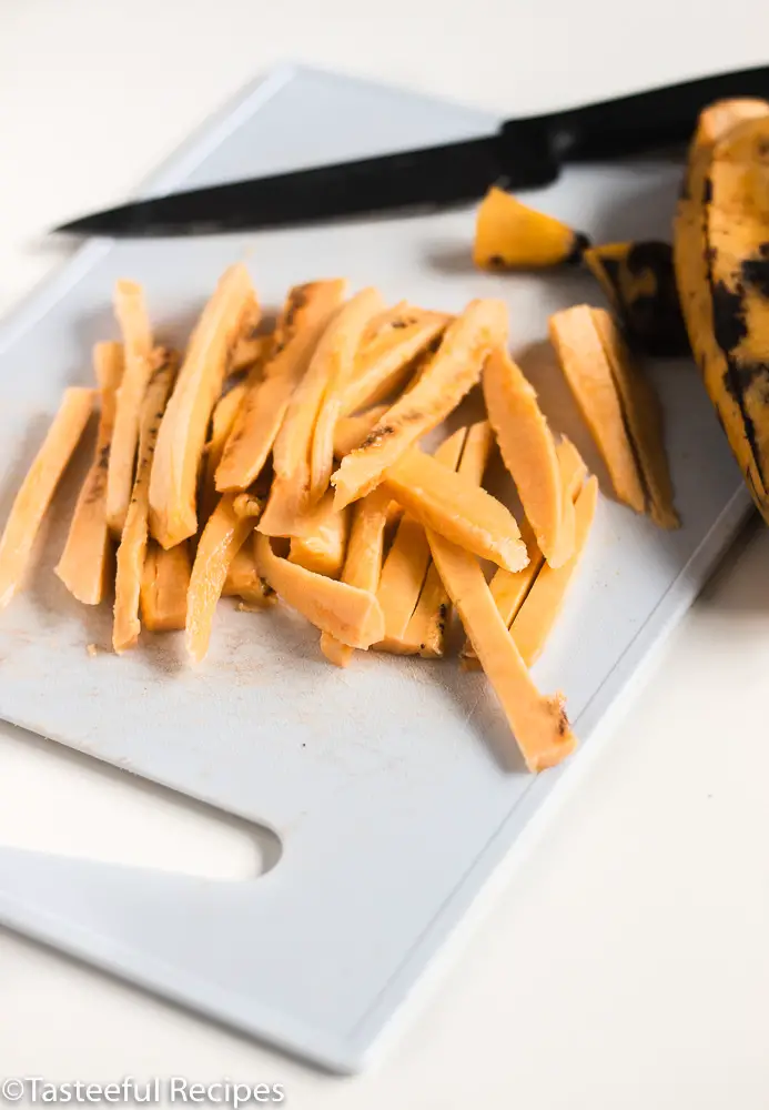Angled shot of plantain being cut into fries
