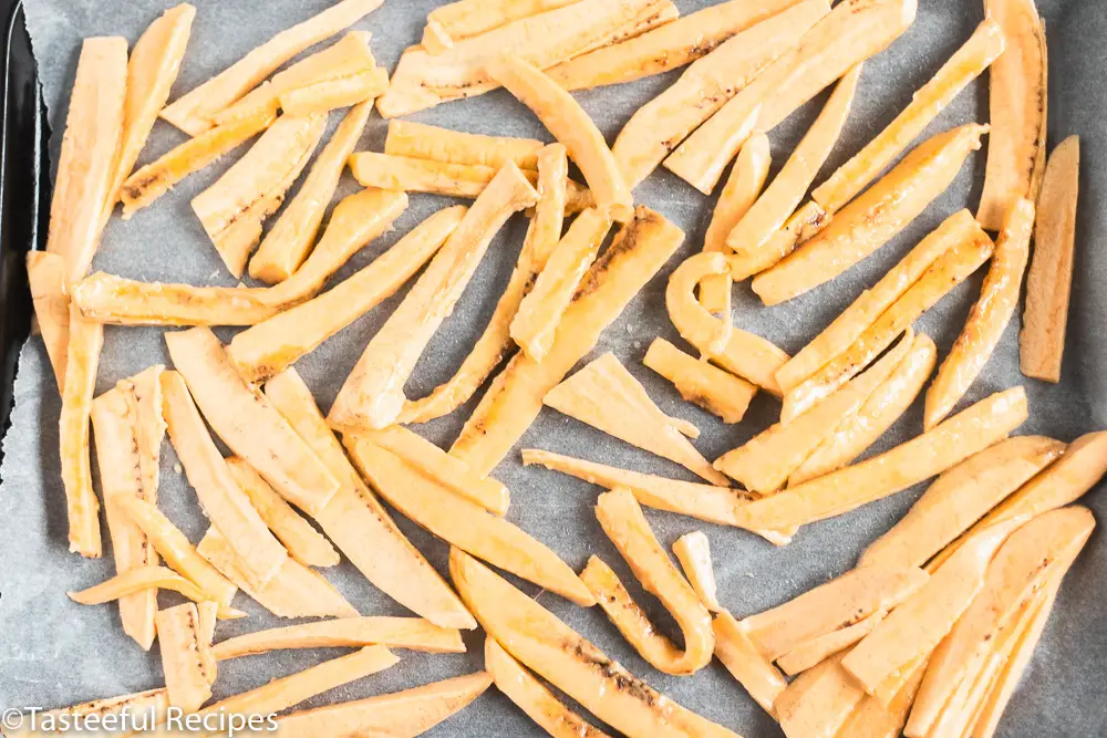 Overhead shot of plantain fries on a baking tray