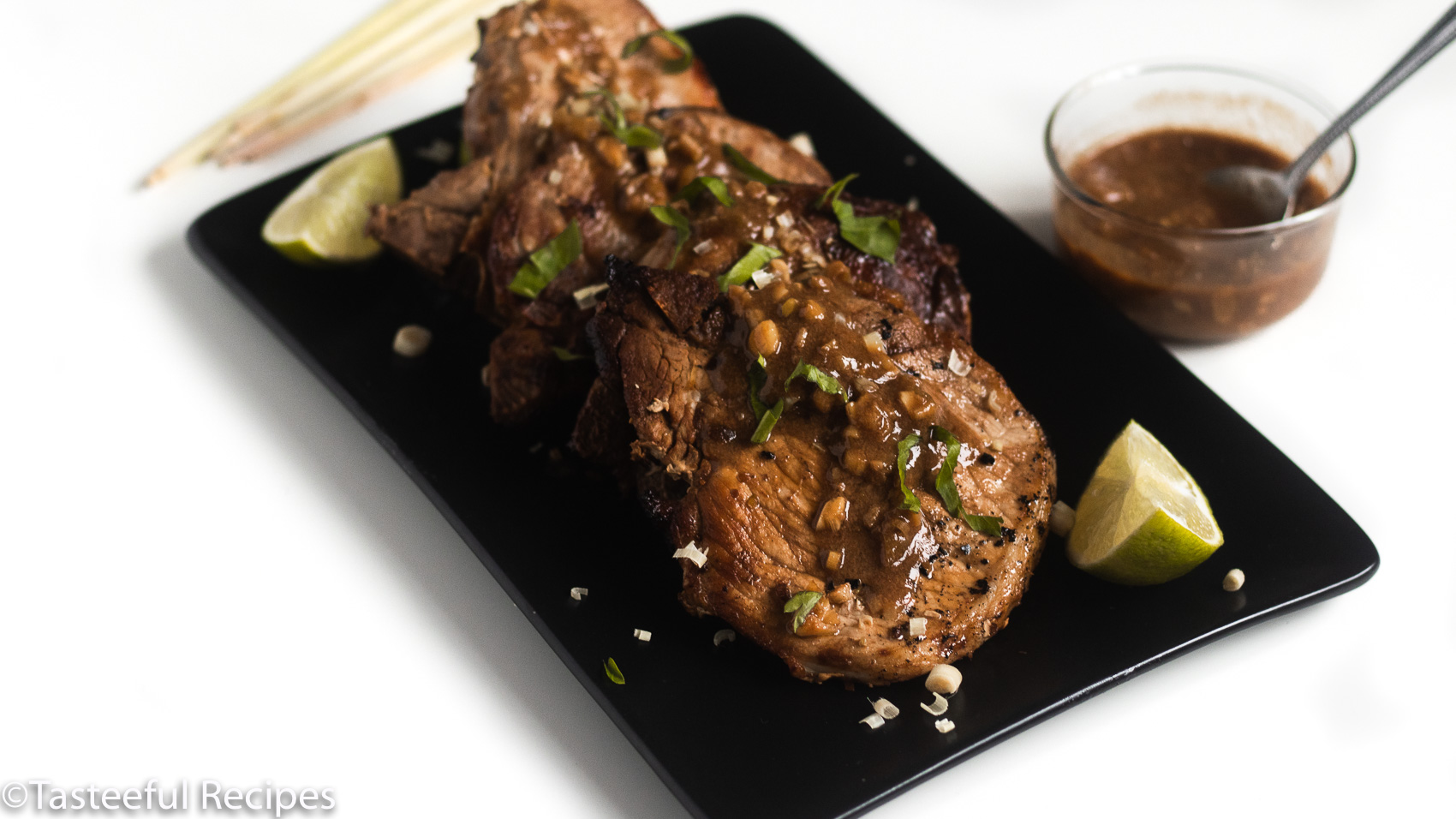 Lemongrass pork chops on a tray with lemongrass sauce drizzled on top