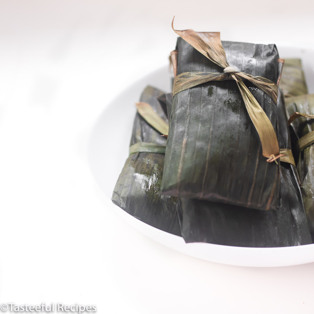 Caribbean conkies wrapped in banana leaves on a plate