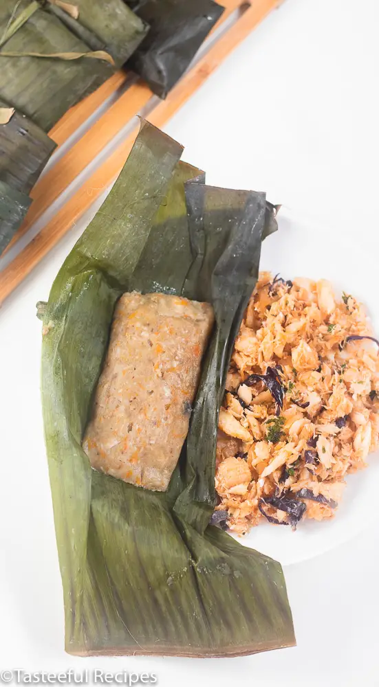 Caribbean conkie in a banana leaf with saltfish on the side