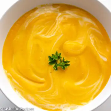 Close up shot of a bowl of coconut pumpkin carrot soup