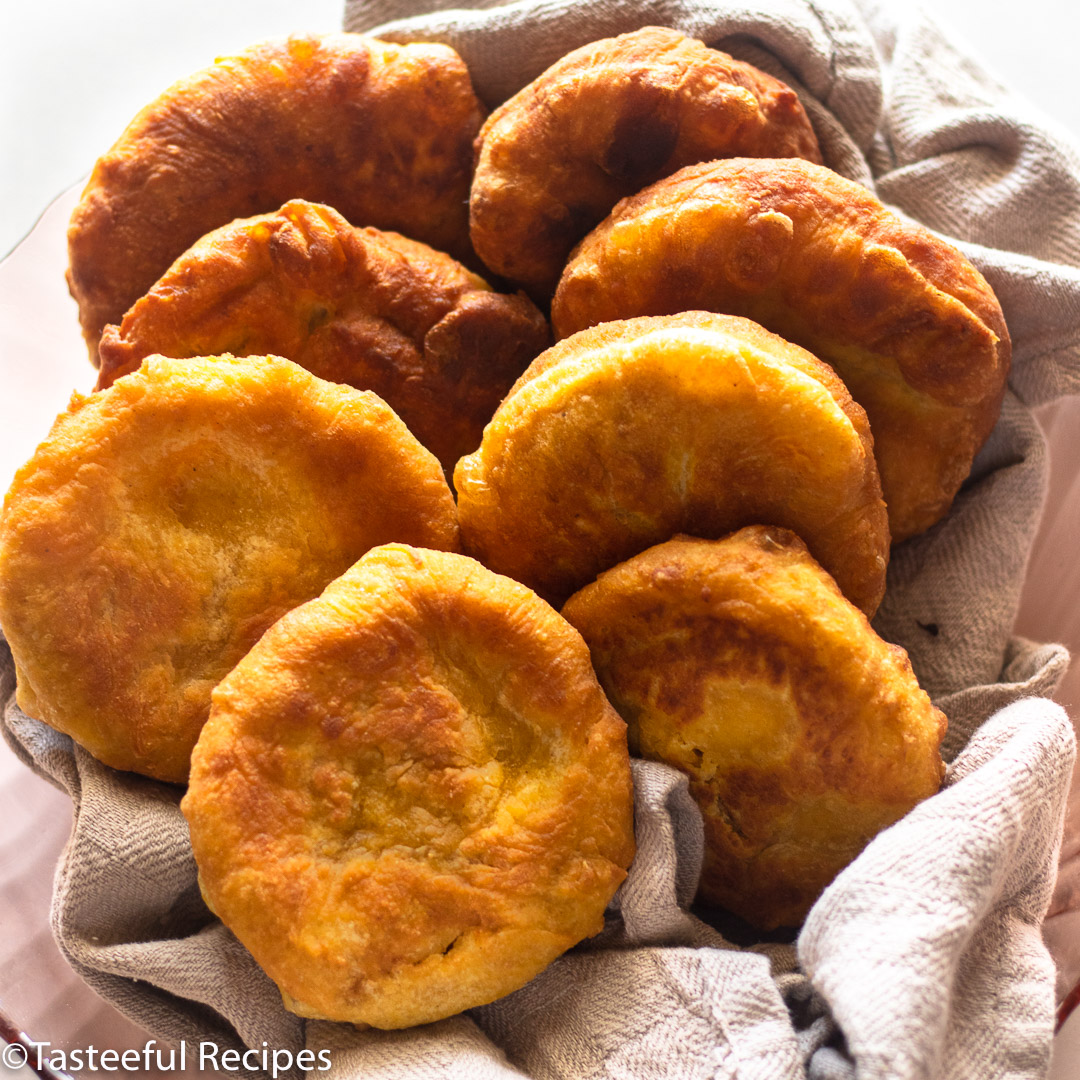 Angled shot of a plate of Caribbean fried pumpkin johnny cakes