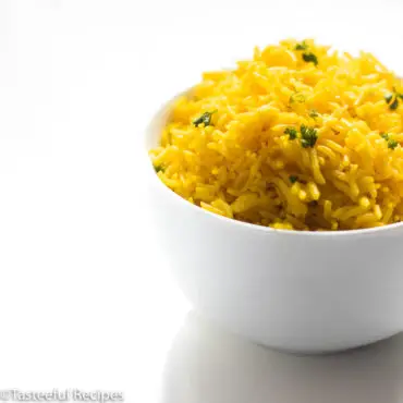 straight arm shot of a bowl of coconut turmeric rice
