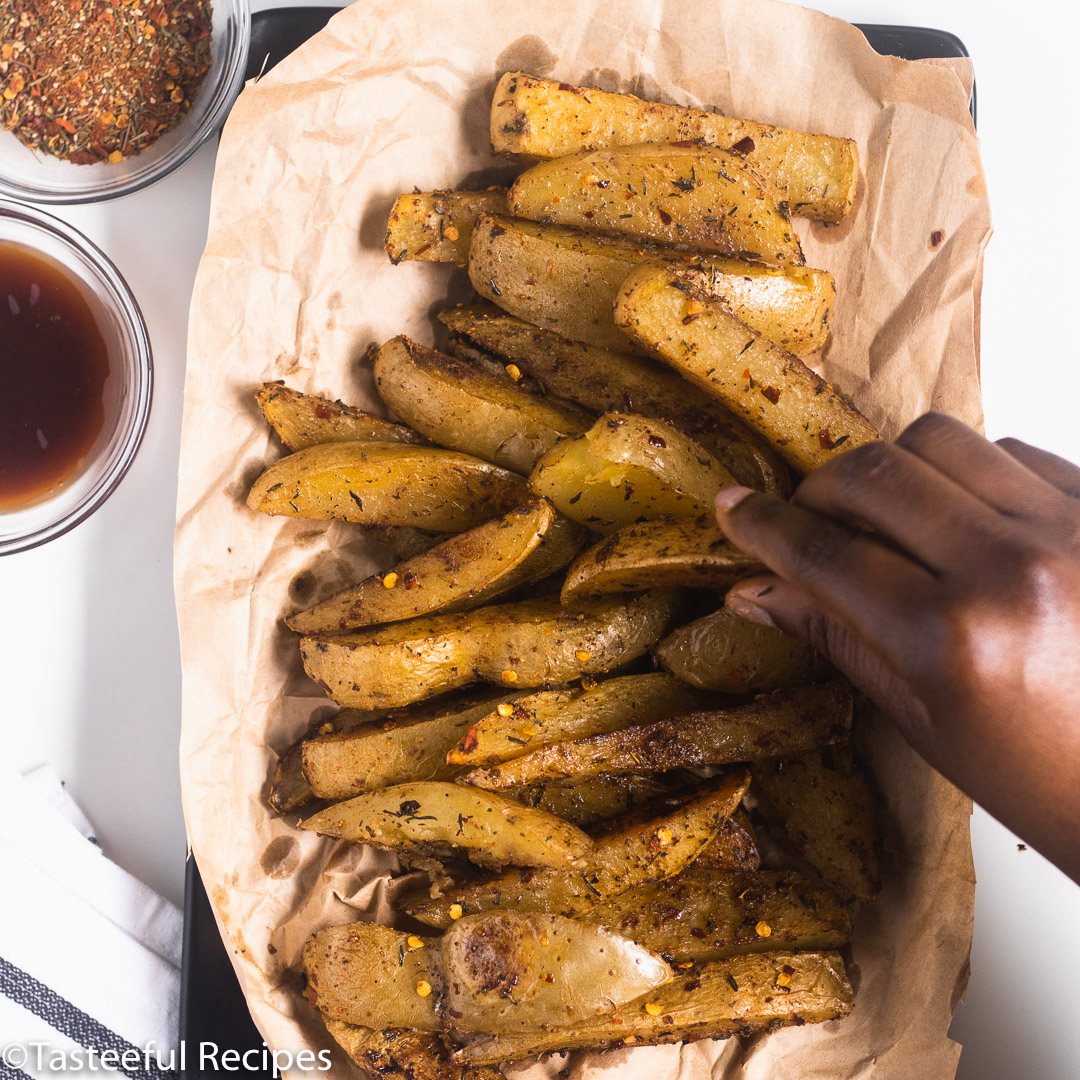 overhead shot of caribbean potato wedges on a tray