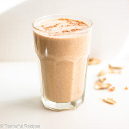 Straight on shot of a glass of Caribbean banana peanut punch