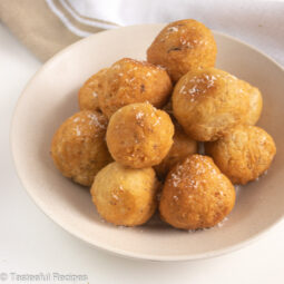 Straight on shot of a plate of Caribbean fried coconut dumplings